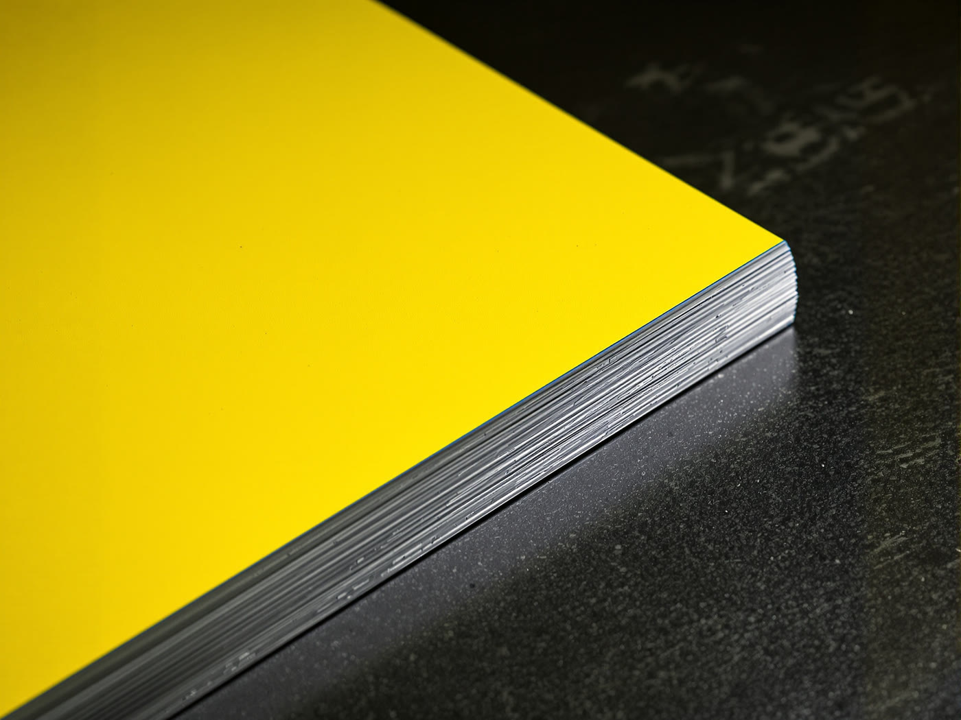A finished full-color printed metal product photographed against a dark ground.